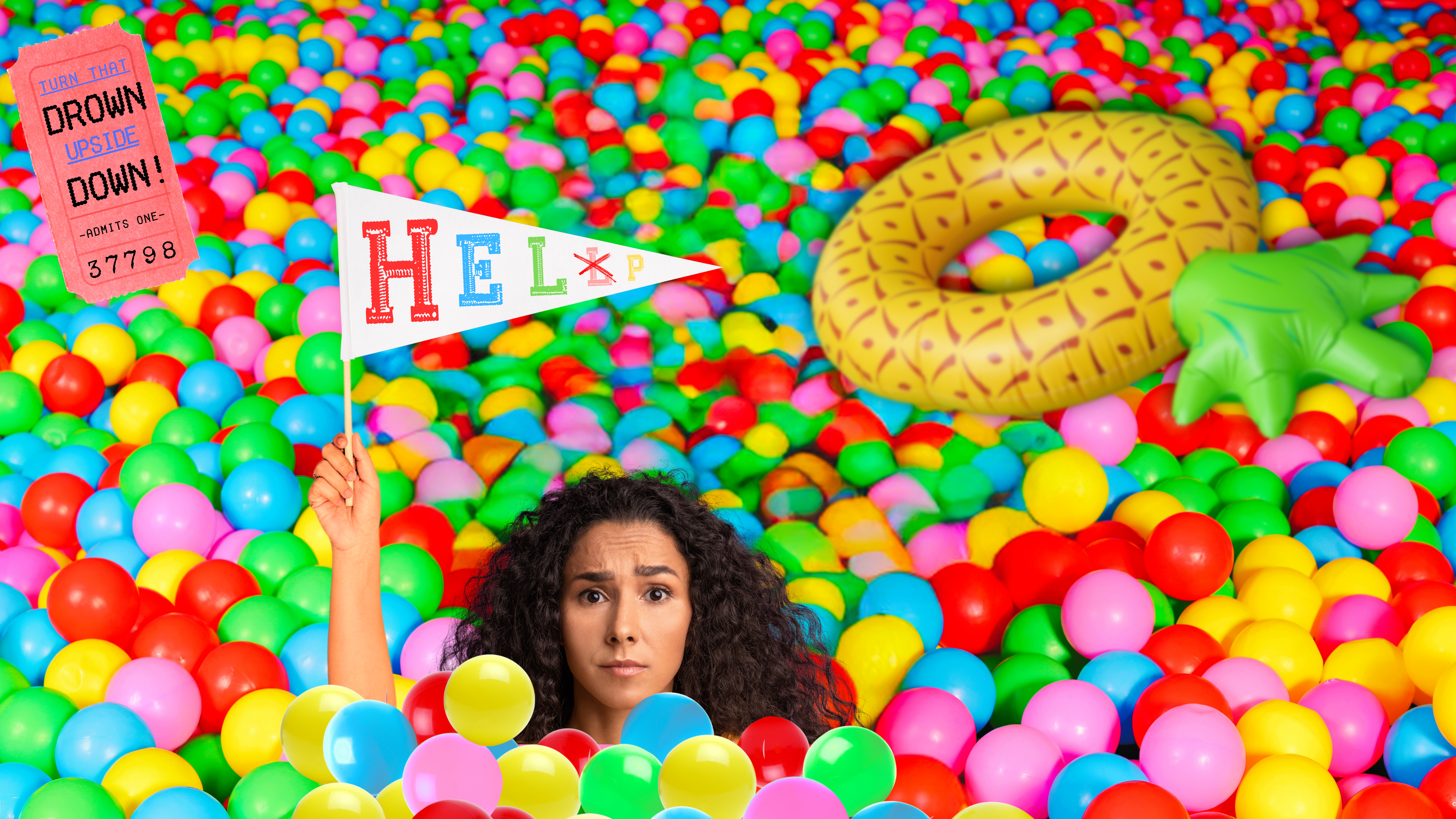 A lady "drowning" in a ball pit as she holds a white pennant that reads "help"